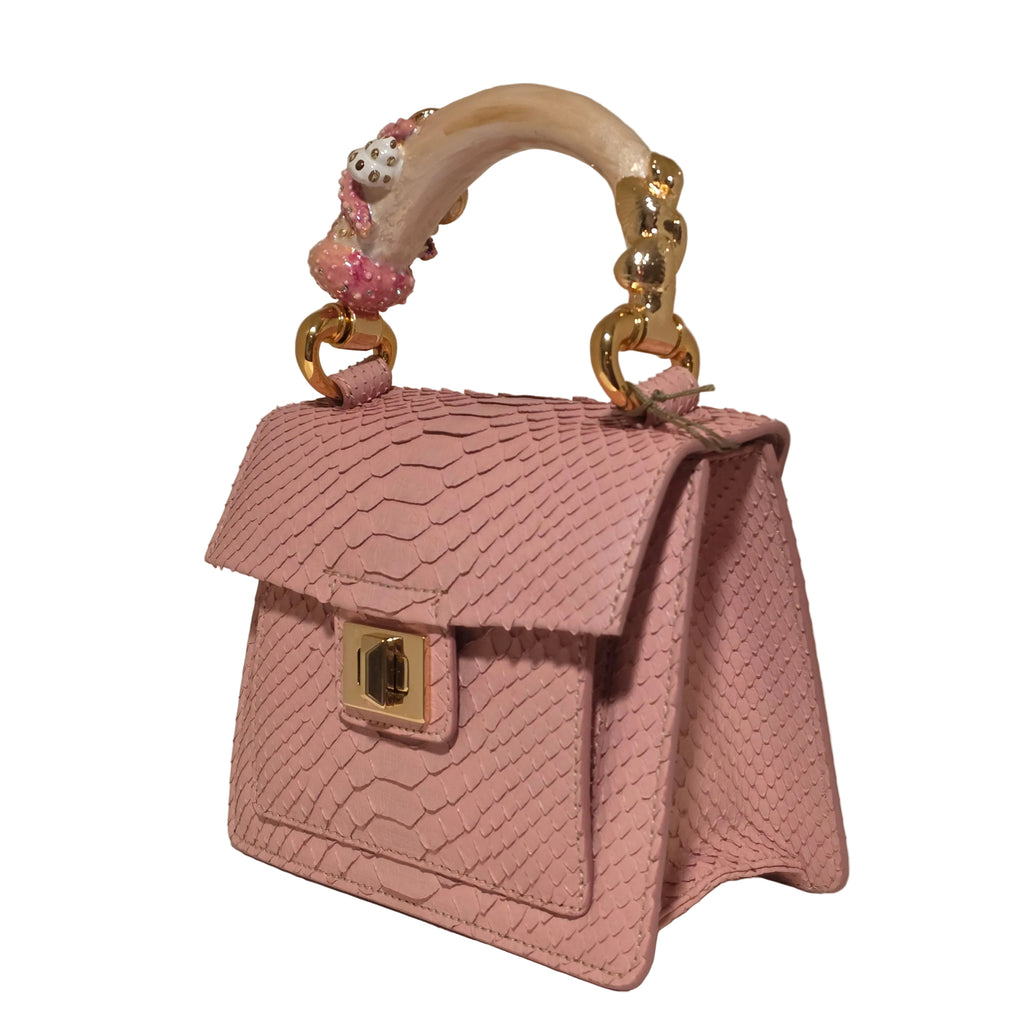 Biagini Art Bag –

Handcrafted in Bologna, Italy since 1968, the Biagini Art Bag is a masterclass in exquisite Italian artistry and uncompromising luxury. Designed to make a statement, this piece showcases genuine python finishes paired with rich, sumptuous suede interior lining. Every detail is meticulously finished, featuring a distinctive hand-painted enameled brass handle and gleaming gold-tone hardware.

Craftsmanship: Made in Italy
Brought to you by Rise And Shine Haven - BellaBarra.store