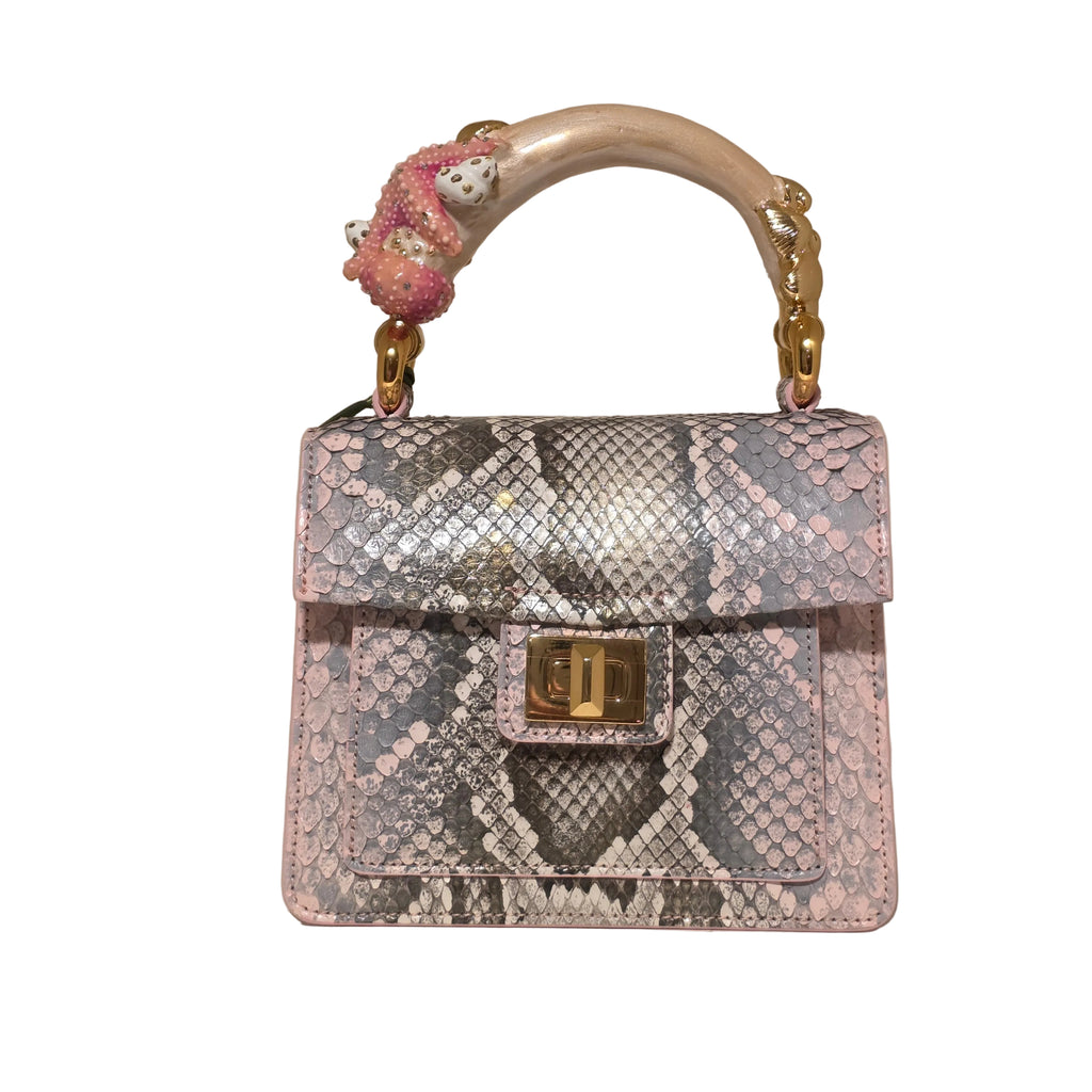 Biagini Art Bag –

Handcrafted in Bologna, Italy since 1968, the Biagini Art Bag is a masterclass in exquisite Italian artistry and uncompromising luxury. Designed to make a statement, this piece showcases genuine python finishes paired with rich, sumptuous suede interior lining. Every detail is meticulously finished, featuring a distinctive hand-painted enameled brass handle and gleaming gold-tone hardware.

Craftsmanship: Made in Italy
Brought to you by Rise And Shine Haven - BellaBarra.store