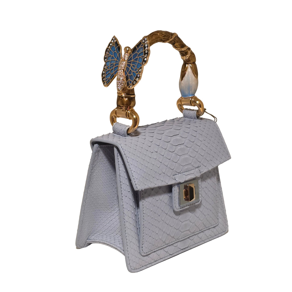 Biagini Art Bag –

Handcrafted in Bologna, Italy since 1968, the Biagini Art Bag is a masterclass in exquisite Italian artistry and uncompromising luxury. Designed to make a statement, this piece showcases genuine python finishes paired with rich, sumptuous suede interior lining. Every detail is meticulously finished, featuring a distinctive hand-painted enameled brass handle and gleaming gold-tone hardware.

Craftsmanship: Made in Italy
Brought to you by Rise And Shine Haven - BellaBarra.store