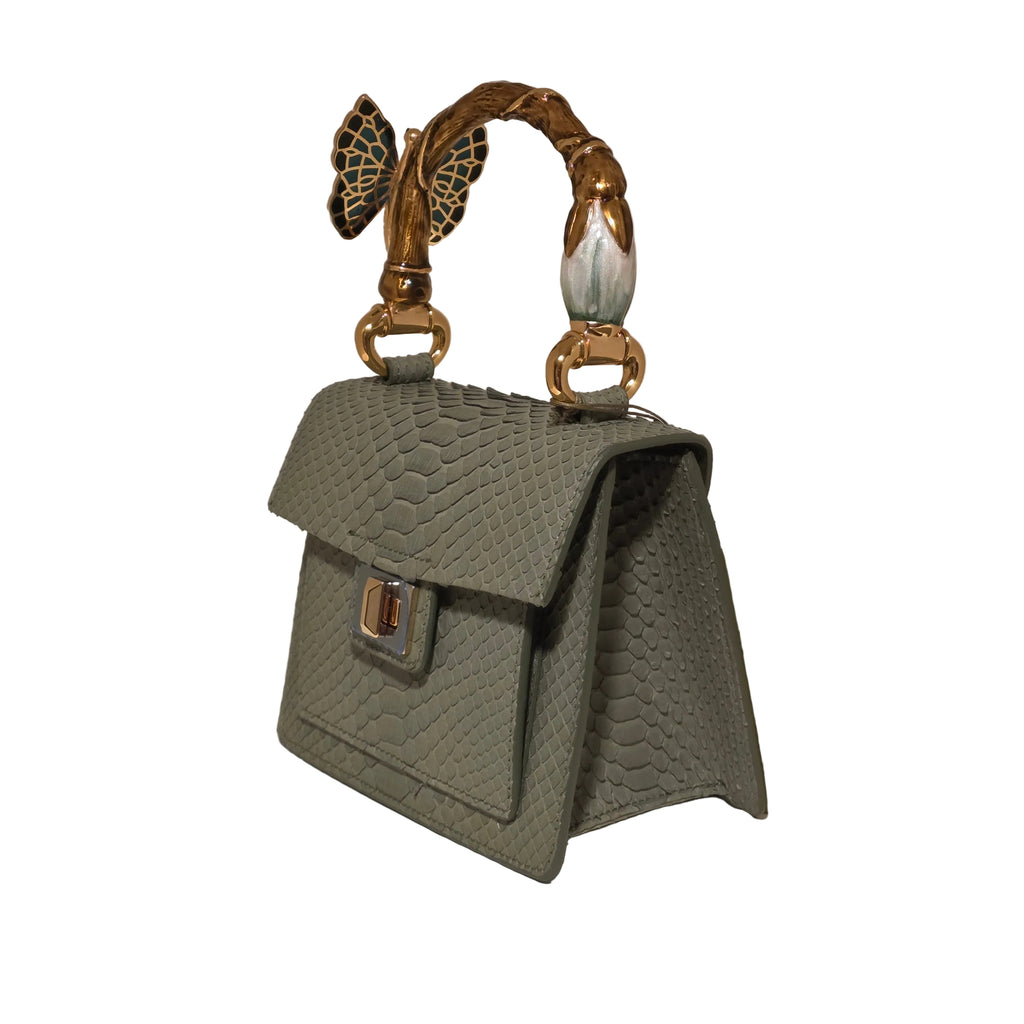 Biagini Art Bag –

Handcrafted in Bologna, Italy since 1968, the Biagini Art Bag is a masterclass in exquisite Italian artistry and uncompromising luxury. Designed to make a statement, this piece showcases genuine python finishes paired with rich, sumptuous suede interior lining. Every detail is meticulously finished, featuring a distinctive hand-painted enameled brass handle and gleaming gold-tone hardware.

Craftsmanship: Made in Italy
Brought to you by Rise And Shine Haven - BellaBarra.store