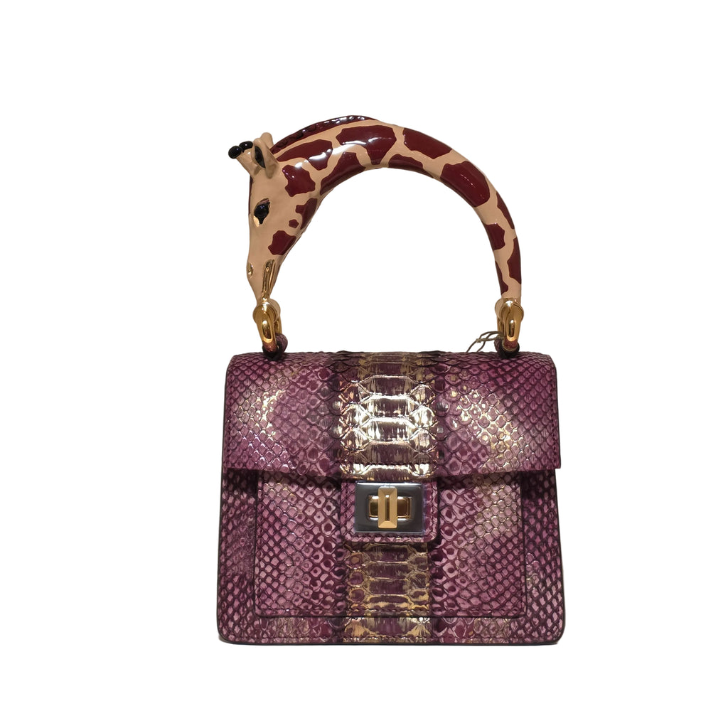 Biagini Art Bag –

Handcrafted in Bologna, Italy since 1968, the Biagini Art Bag is a masterclass in exquisite Italian artistry and uncompromising luxury. Designed to make a statement, this piece showcases genuine python finishes paired with rich, sumptuous suede interior lining. Every detail is meticulously finished, featuring a distinctive hand-painted enameled brass handle and gleaming gold-tone hardware.

Craftsmanship: Made in Italy
Brought to you by Rise And Shine Haven - BellaBarra.store