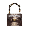 Biagini Art Bag –

Handcrafted in Bologna, Italy since 1968, the Biagini Art Bag is a masterclass in exquisite Italian artistry and uncompromising luxury. Designed to make a statement, this piece showcases genuine python finishes paired with rich, sumptuous suede interior lining. Every detail is meticulously finished, featuring a distinctive hand-painted enameled brass handle and gleaming gold-tone hardware.

Craftsmanship: Made in Italy
Brought to you by Rise And Shine Haven - BellaBarra.store