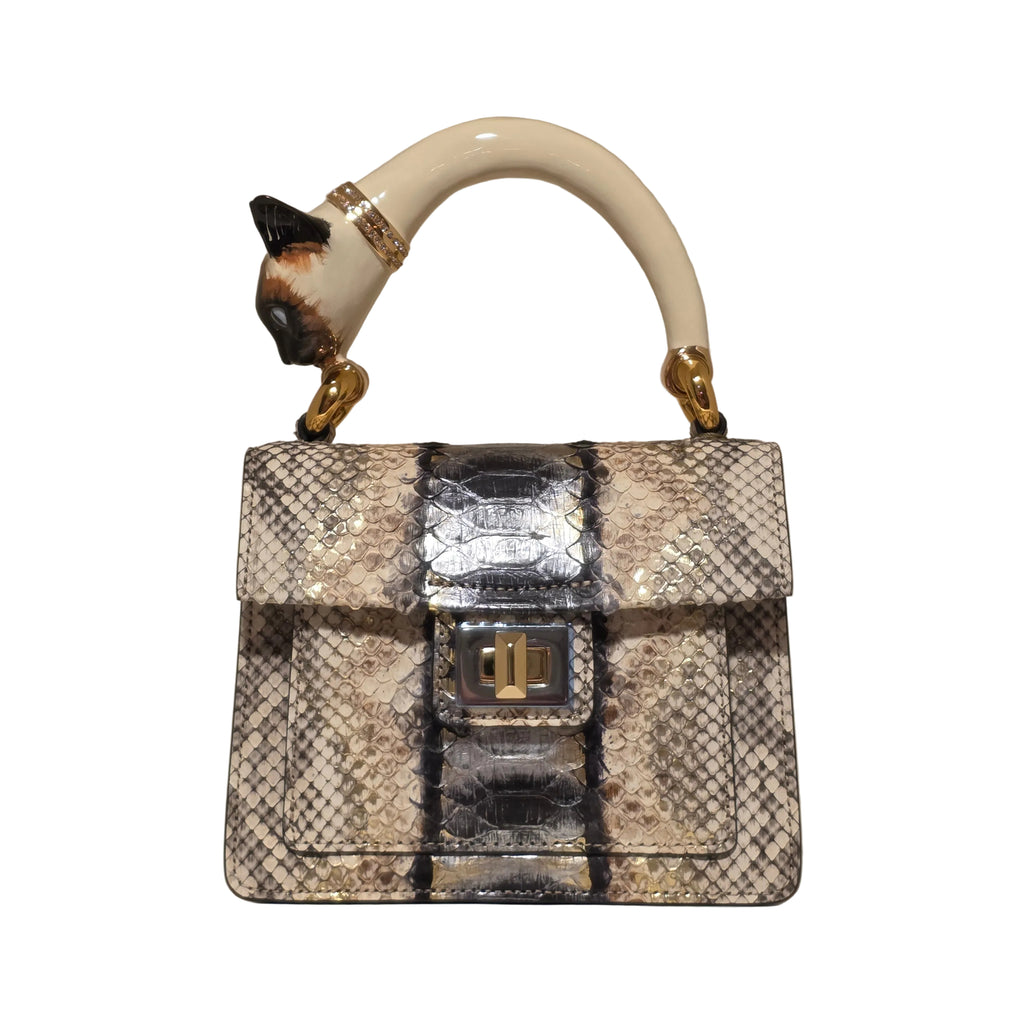 Biagini Art Bag –

Handcrafted in Bologna, Italy since 1968, the Biagini Art Bag is a masterclass in exquisite Italian artistry and uncompromising luxury. Designed to make a statement, this piece showcases genuine python finishes paired with rich, sumptuous suede interior lining. Every detail is meticulously finished, featuring a distinctive hand-painted enameled brass handle and gleaming gold-tone hardware.

Craftsmanship: Made in Italy
Brought to you by Rise And Shine Haven - BellaBarra.store