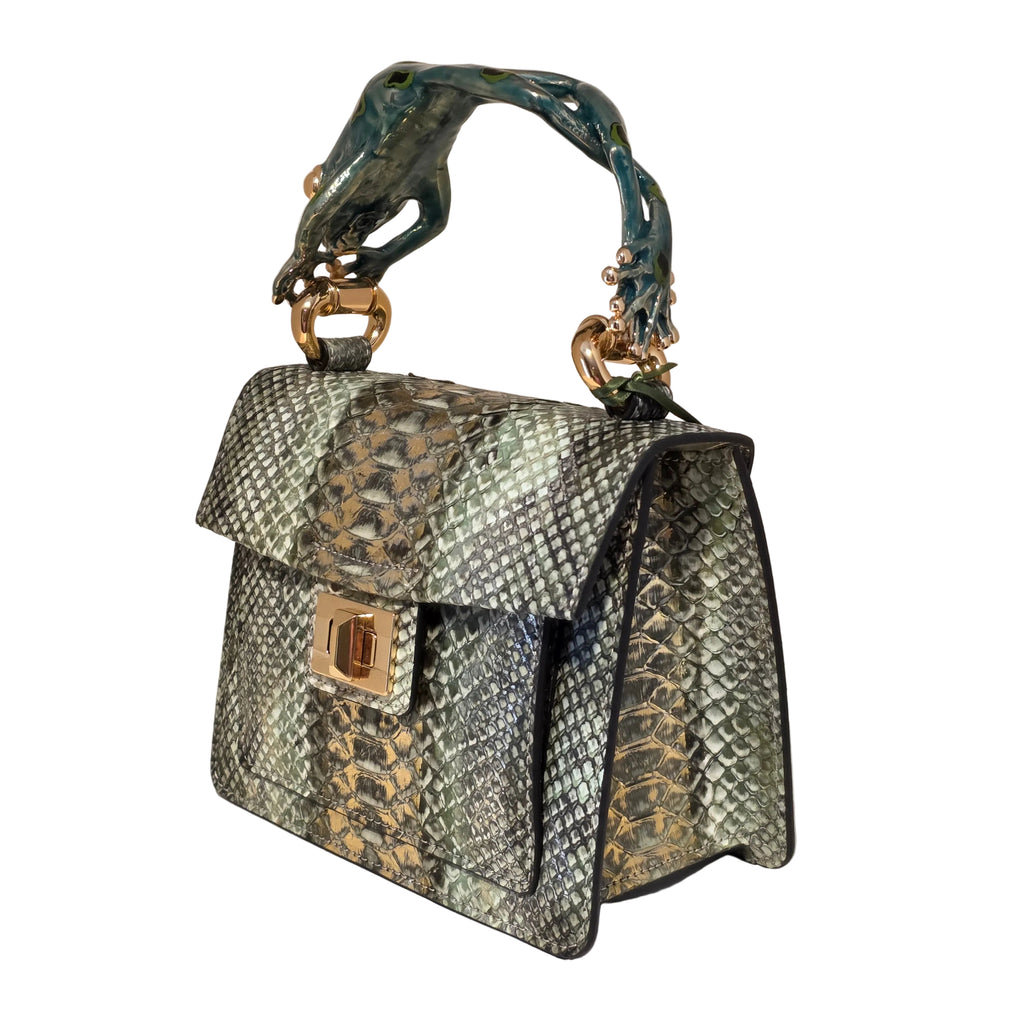 Biagini Art Bag –

Handcrafted in Bologna, Italy since 1968, the Biagini Art Bag is a masterclass in exquisite Italian artistry and uncompromising luxury. Designed to make a statement, this piece showcases genuine python finishes paired with rich, sumptuous suede interior lining. Every detail is meticulously finished, featuring a distinctive hand-painted enameled brass handle and gleaming gold-tone hardware.

Craftsmanship: Made in Italy
Brought to you by Rise And Shine Haven - BellaBarra.store