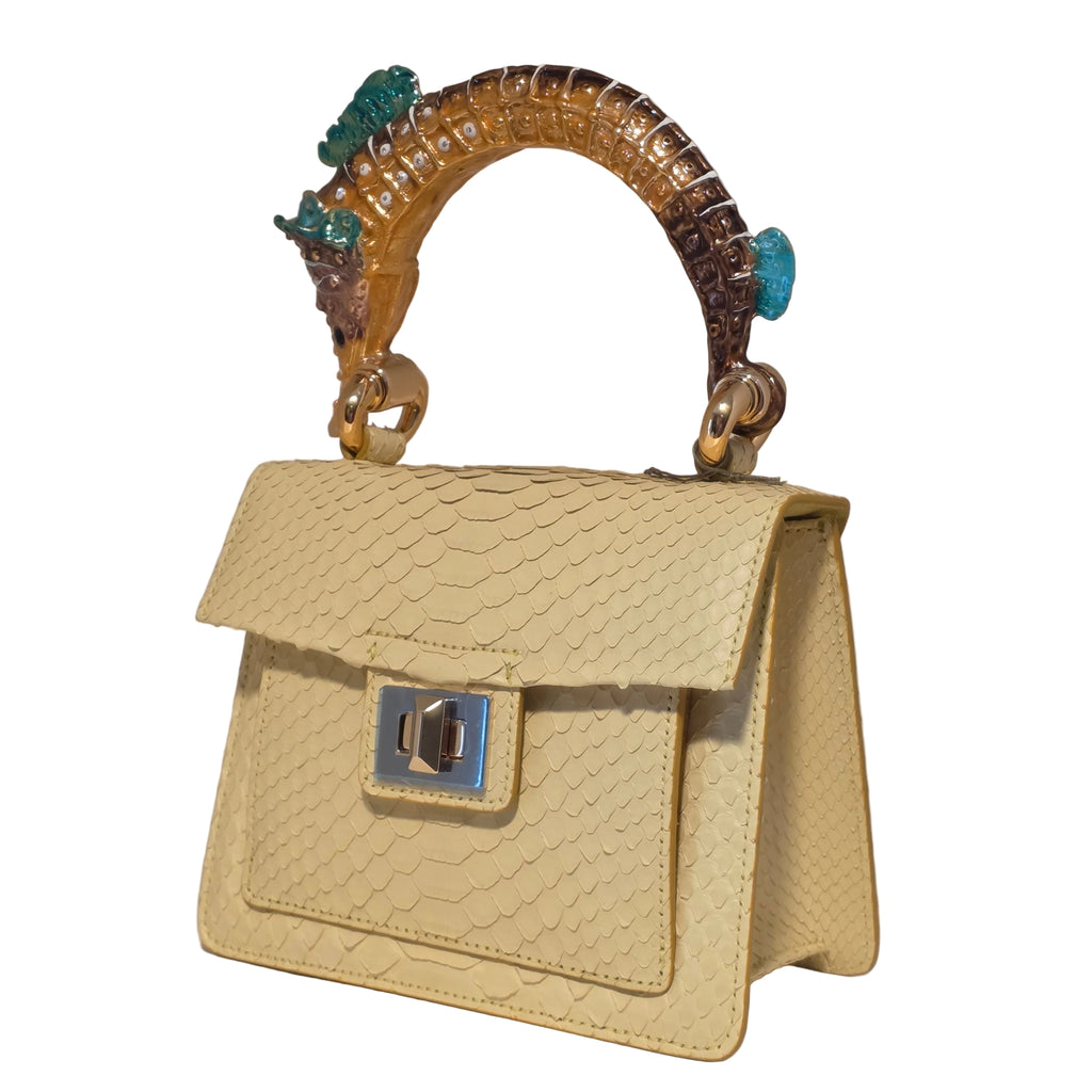 Biagini Art Bag –

Handcrafted in Bologna, Italy since 1968, the Biagini Art Bag is a masterclass in exquisite Italian artistry and uncompromising luxury. Designed to make a statement, this piece showcases genuine python finishes paired with rich, sumptuous suede interior lining. Every detail is meticulously finished, featuring a distinctive hand-painted enameled brass handle and gleaming gold-tone hardware.

Craftsmanship: Made in Italy
Brought to you by Rise And Shine Haven - BellaBarra.store