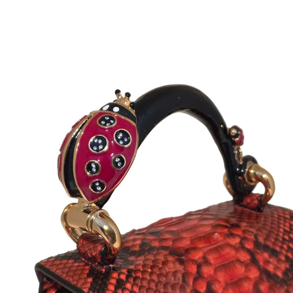 Biagini Art Bag –

Handcrafted in Bologna, Italy since 1968, the Biagini Art Bag is a masterclass in exquisite Italian artistry and uncompromising luxury. Designed to make a statement, this piece showcases genuine python finishes paired with rich, sumptuous suede interior lining. Every detail is meticulously finished, featuring a distinctive hand-painted enameled brass handle and gleaming gold-tone hardware.

Craftsmanship: Made in Italy
Brought to you by Rise And Shine Haven - BellaBarra.store