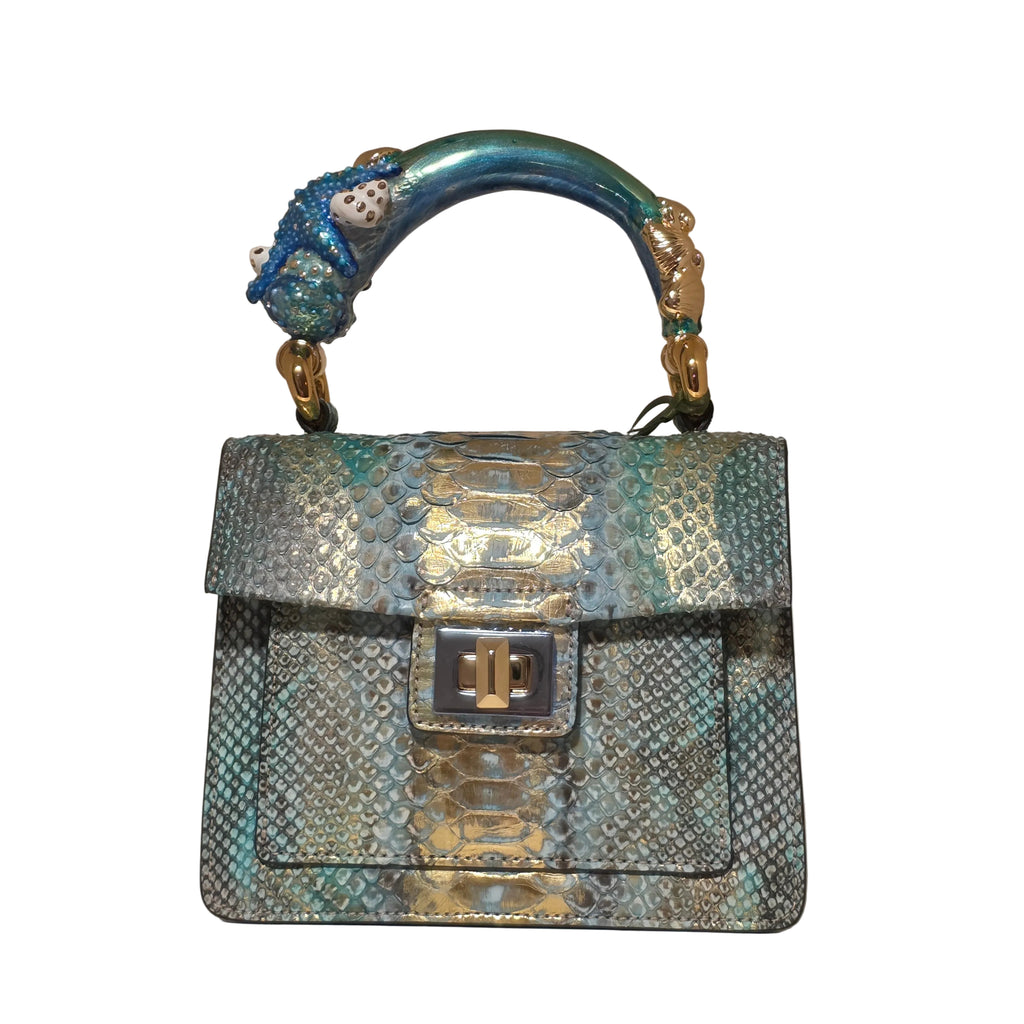 Biagini Art Bag –

Handcrafted in Bologna, Italy since 1968, the Biagini Art Bag is a masterclass in exquisite Italian artistry and uncompromising luxury. Designed to make a statement, this piece showcases genuine python finishes paired with rich, sumptuous suede interior lining. Every detail is meticulously finished, featuring a distinctive hand-painted enameled brass handle and gleaming gold-tone hardware.

Craftsmanship: Made in Italy
Brought to you by Rise And Shine Haven - BellaBarra.store