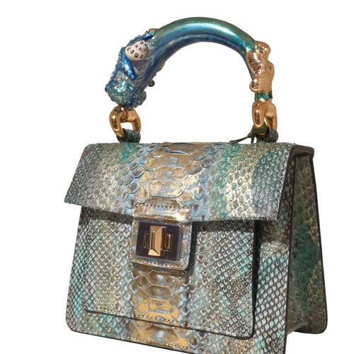 Biagini Art Bag –

Handcrafted in Bologna, Italy since 1968, the Biagini Art Bag is a masterclass in exquisite Italian artistry and uncompromising luxury. Designed to make a statement, this piece showcases genuine python finishes paired with rich, sumptuous suede interior lining. Every detail is meticulously finished, featuring a distinctive hand-painted enameled brass handle and gleaming gold-tone hardware.

Craftsmanship: Made in Italy
Brought to you by Rise And Shine Haven - BellaBarra.store