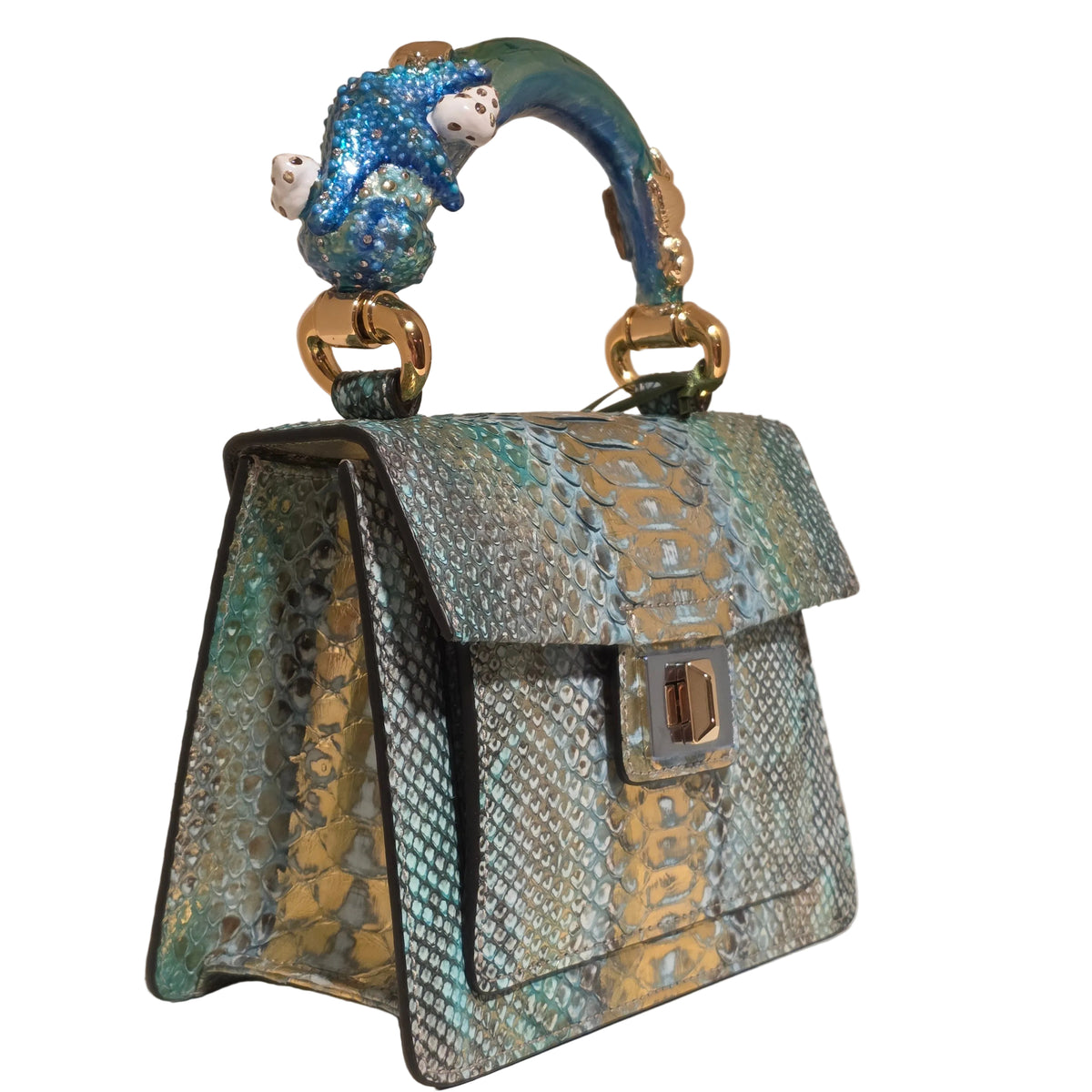 Biagini Art Bag –

Handcrafted in Bologna, Italy since 1968, the Biagini Art Bag is a masterclass in exquisite Italian artistry and uncompromising luxury. Designed to make a statement, this piece showcases genuine python finishes paired with rich, sumptuous suede interior lining. Every detail is meticulously finished, featuring a distinctive hand-painted enameled brass handle and gleaming gold-tone hardware.

Craftsmanship: Made in Italy
Brought to you by Rise And Shine Haven - BellaBarra.store